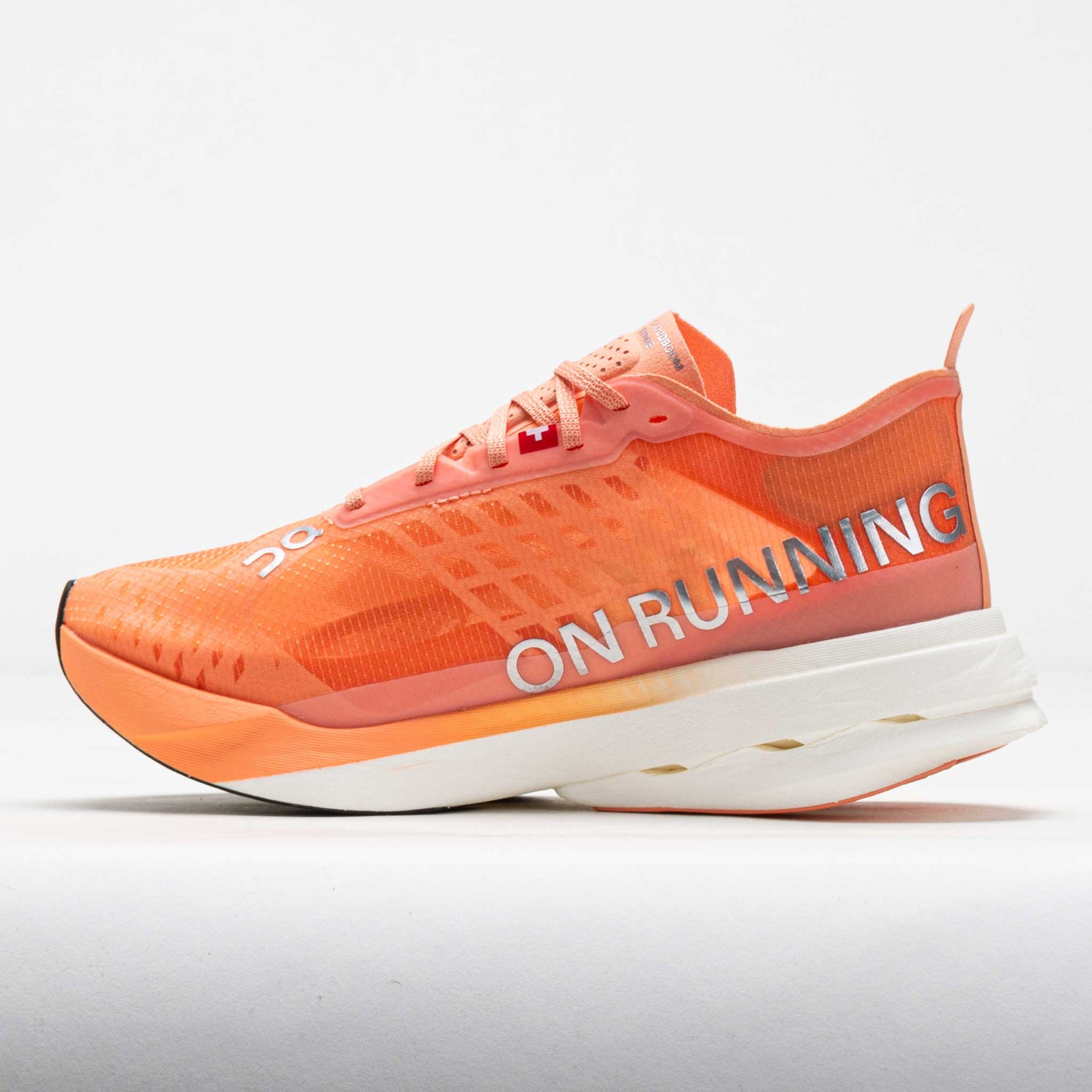 On Cloudboom Strike women's running shoe in orange sunstone colorway with white sole