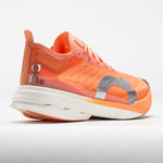 On Cloudboom Strike women's running shoe in orange sunstone colorway with white sole