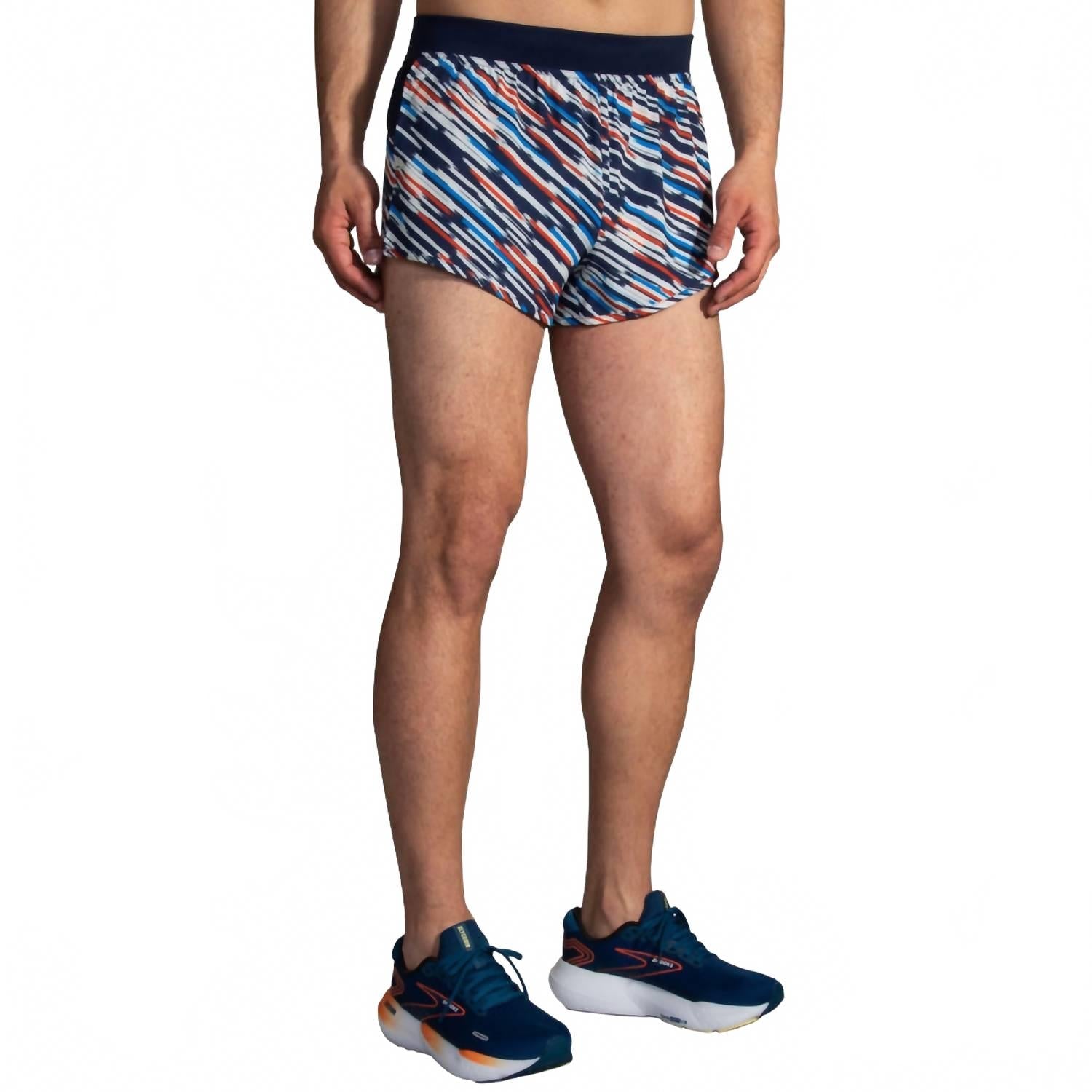 Brooks Sherpa 3-inch Split Short in Motion Print worn by male model with running shoes