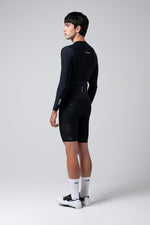 Male model wearing black Gobik Avalon long sleeve cycling jersey and shorts