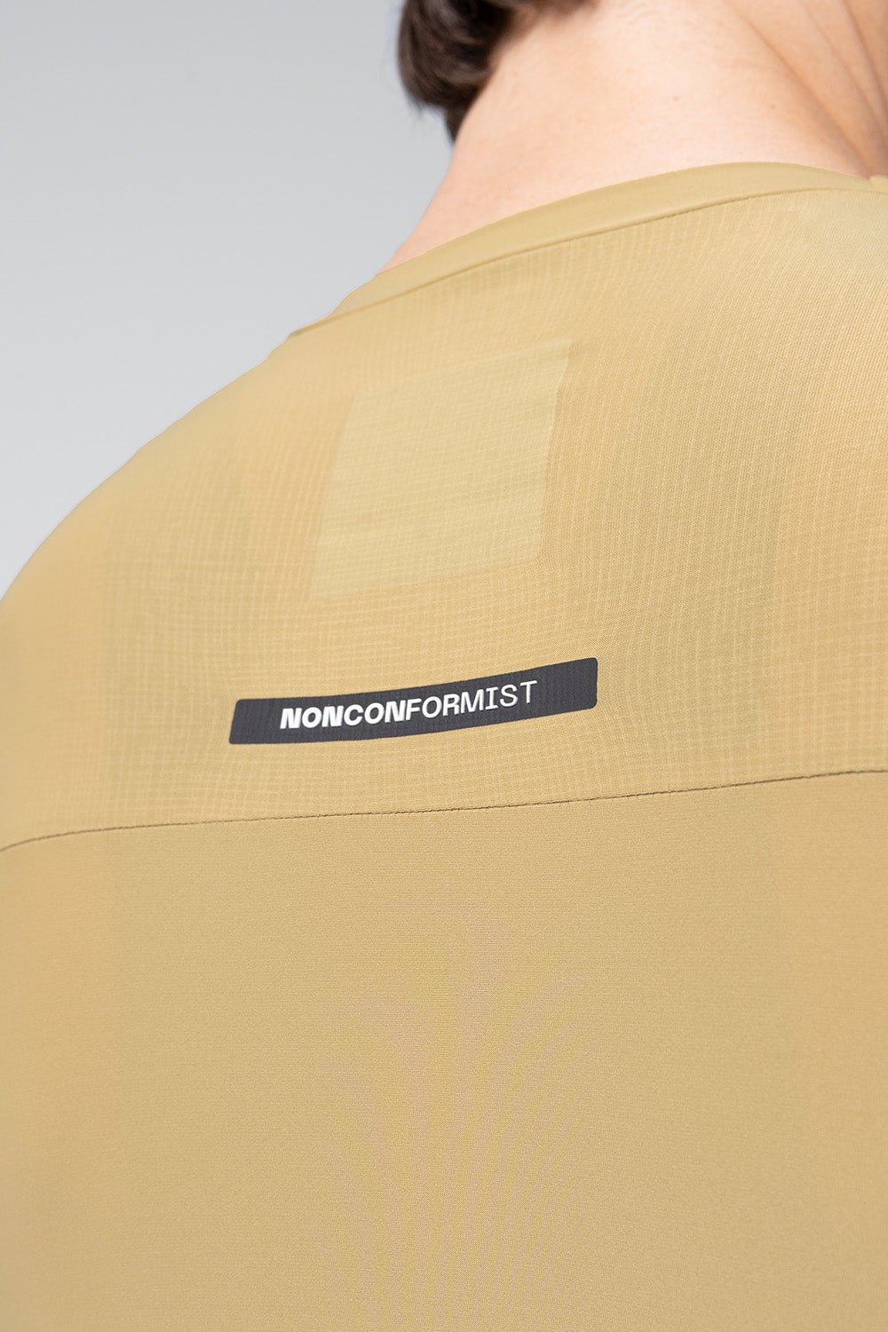 Close-up detail of Gobik Avalon jersey back showing NONCONFORMIST label in Keemun color