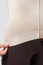 Close-up detail of Gobik CX Pro 4.0 jersey hem in almond color with elastic band