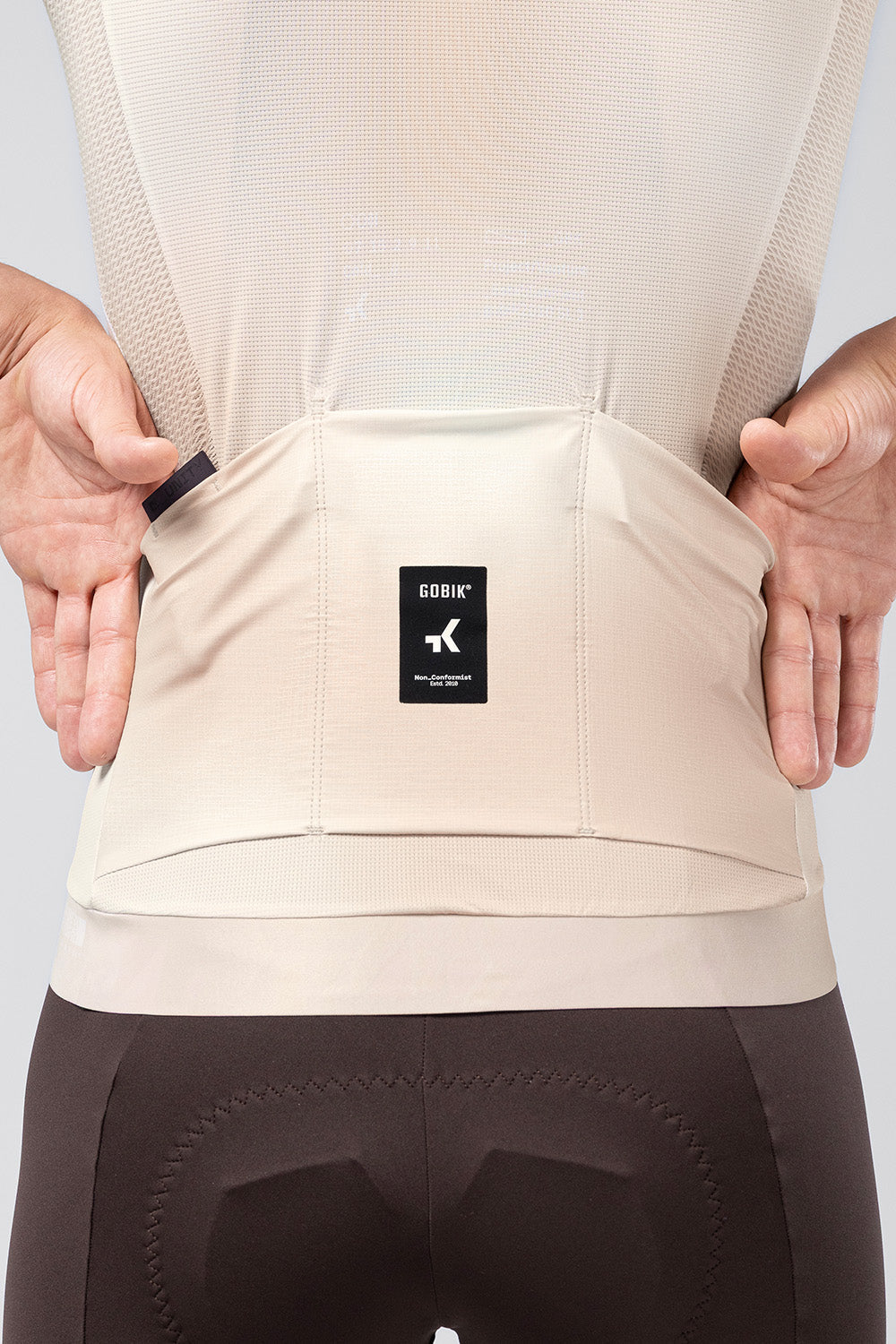 Back pocket detail of Gobik CX Pro 4.0 almond jersey showing Gobik brand label and storage pockets