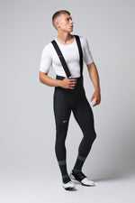 Male cyclist wearing black Gobik Absolute 7.0 bib shorts with white jersey