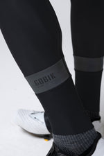 Close-up of Gobik black cycling bib shorts showing brand logo and fabric details