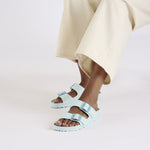 Birkenstock Arizona EVA sandals in Surf Green with double buckle straps on model