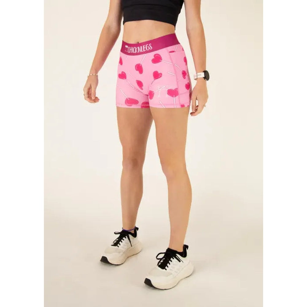 Pink ChicknLegs compression shorts with heart pattern worn by model