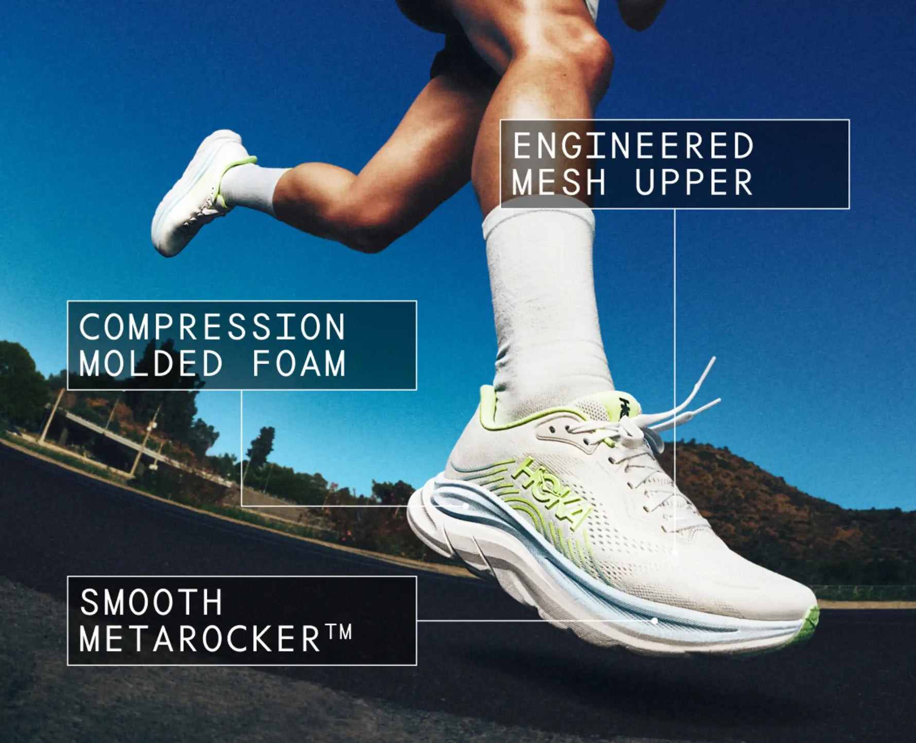 HOKA Clifton 11 running shoe in white with green accents worn by runner mid-stride