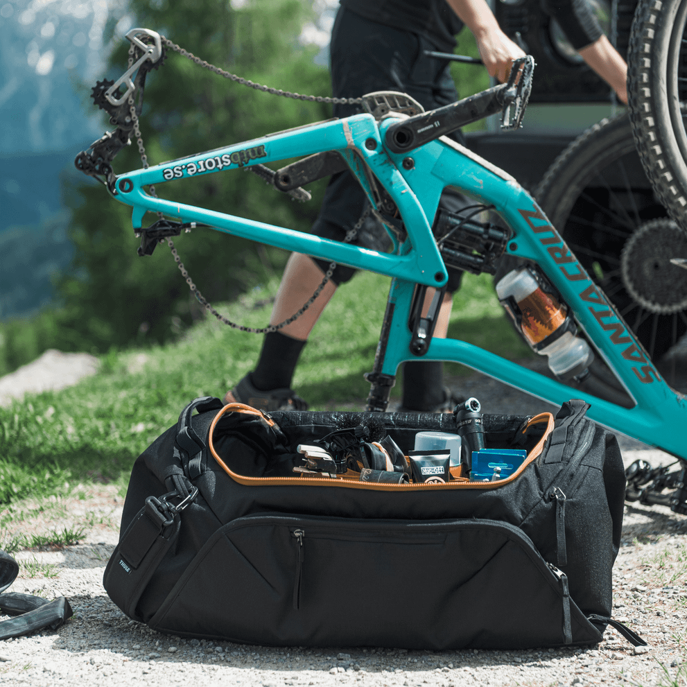 Thule RoundTrip bike duffel bag open showing bike frame storage with tools