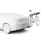 Thule Helium Pro 3 bike hitch rack mounted on white car with bicycle loaded