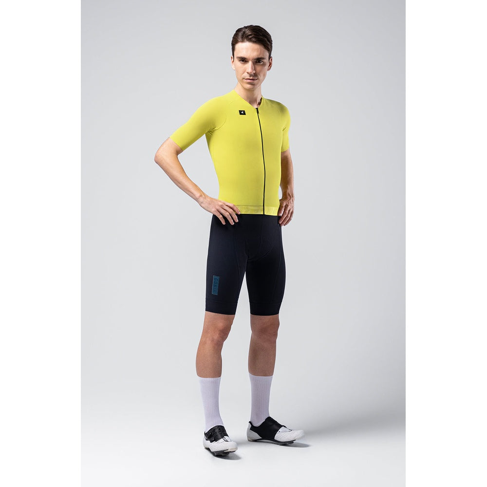 Male cyclist wearing bright yellow Gobik CX jersey with black cycling shorts