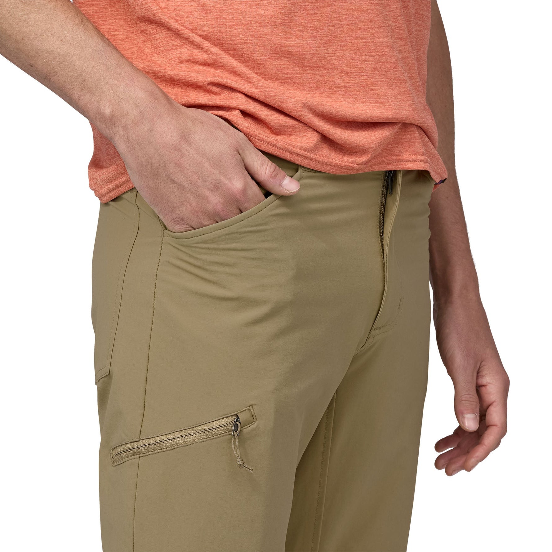 Man wearing olive green Patagonia Quandary convertible pants with hand in pocket