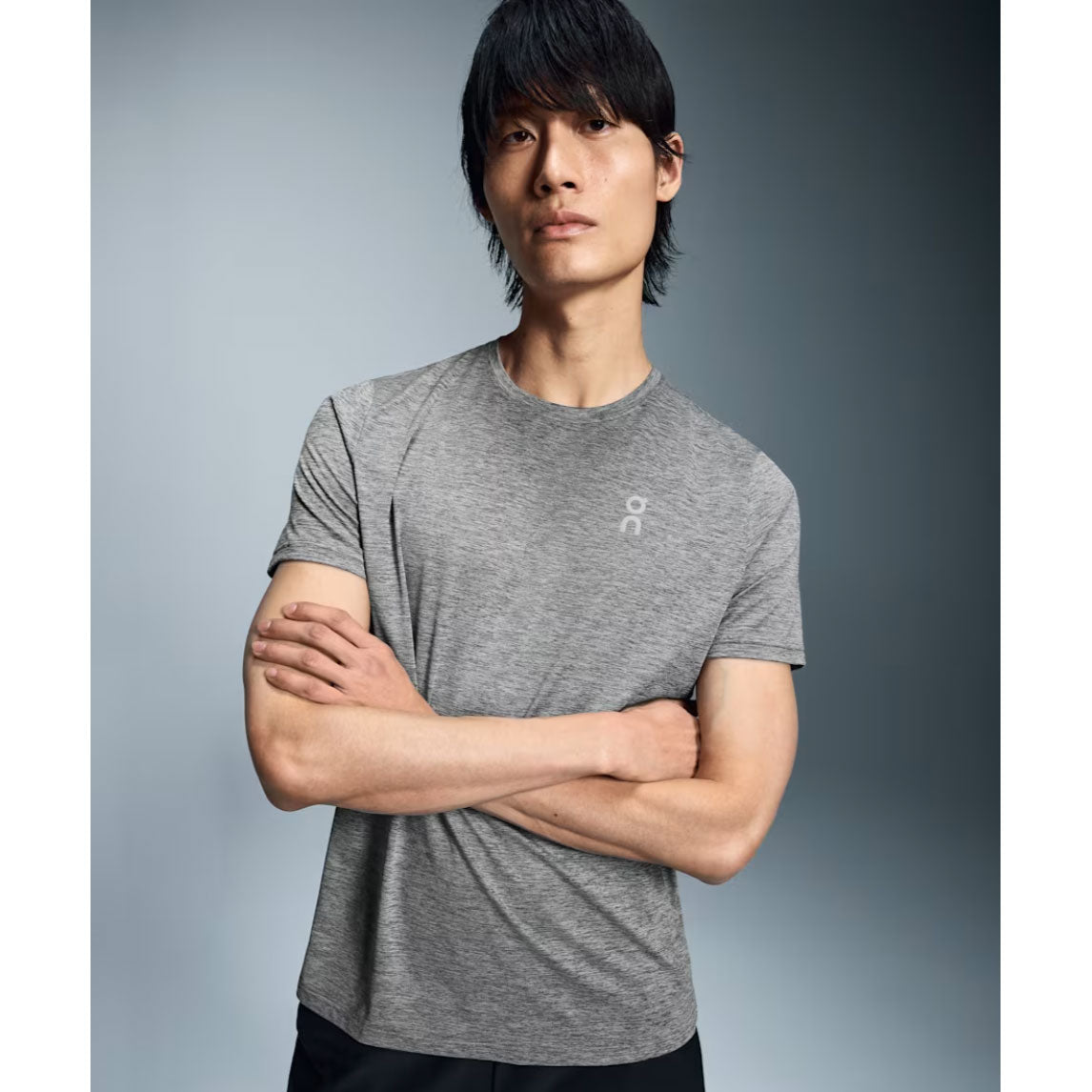 Man wearing On Core Long-T heather grey t-shirt with arms crossed
