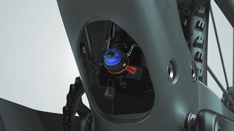 Close-up of Scott Spark RC World Cup carbon frame pivot linkage with blue anodized hardware