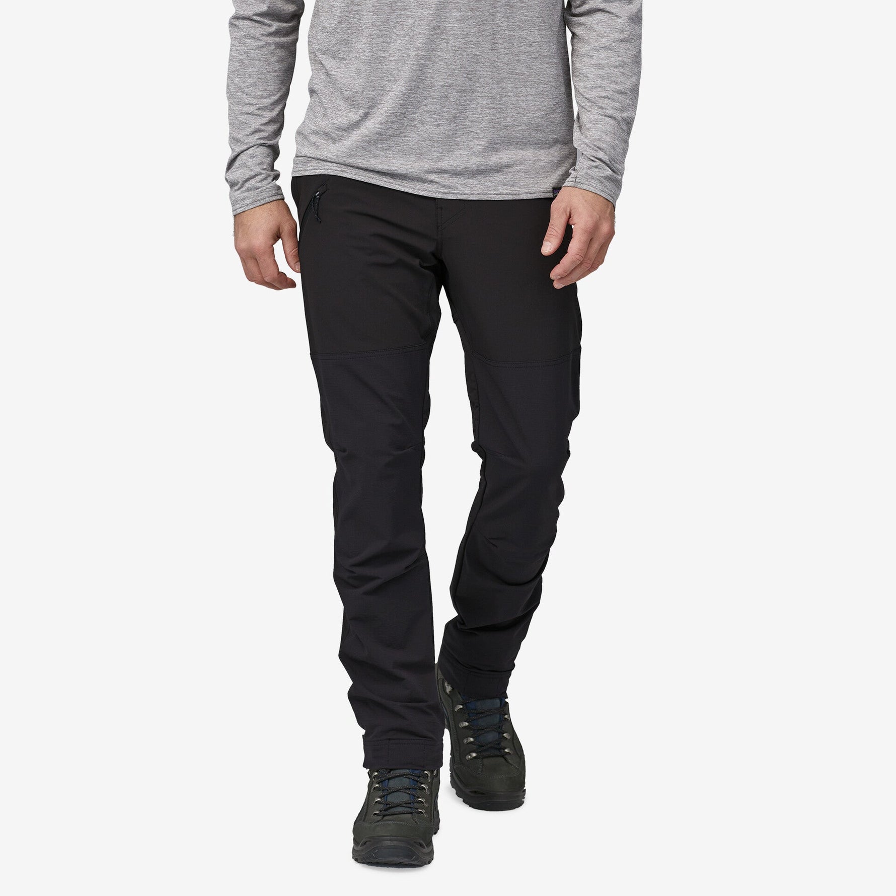 Man wearing black Patagonia Point Peak Trail Pants with gray shirt and hiking boots