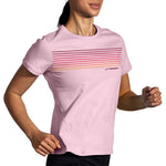 Woman wearing Brooks Distance Short Sleeve running shirt in quartz with gradient stripe design