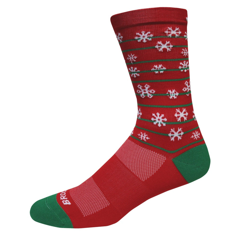 Brooks Pacesetter crew sock in red with white snowflakes and green accents holiday design
