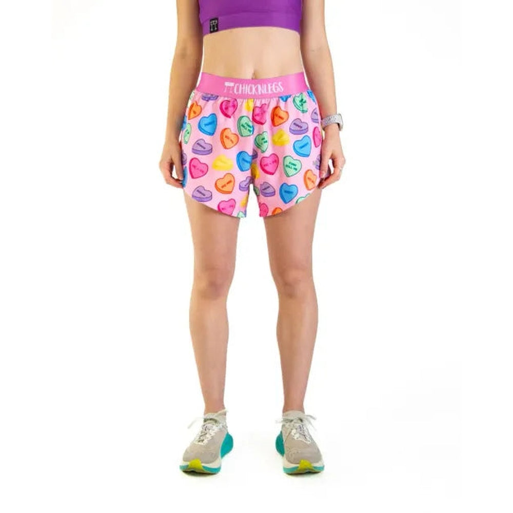 Woman wearing ChicknLegs candy hearts print running shorts with colorful heart pattern