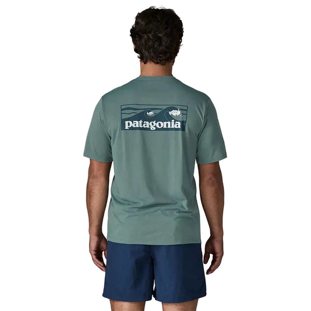 Back view of man wearing Patagonia sage green t-shirt with logo