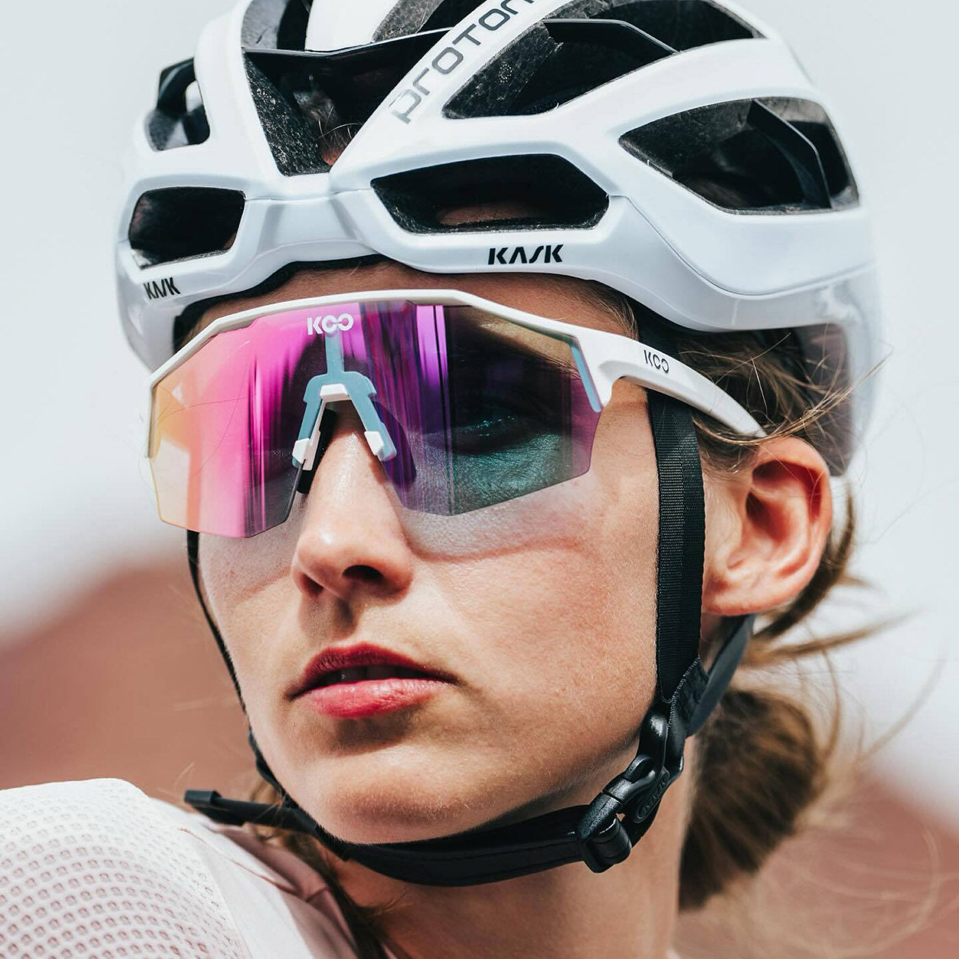 KOO cycling sunglasses with white frame and photochromic lenses on female cyclist