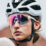 KOO Alibi cycling sunglasses in white with photochromic fuchsia lenses worn by cyclist