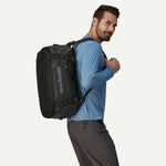 Man wearing Patagonia Black Hole 40L Duffel as backpack in black