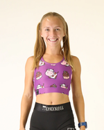Female model wearing ChicknLegs purple Choccy Cows sports bra with cartoon print