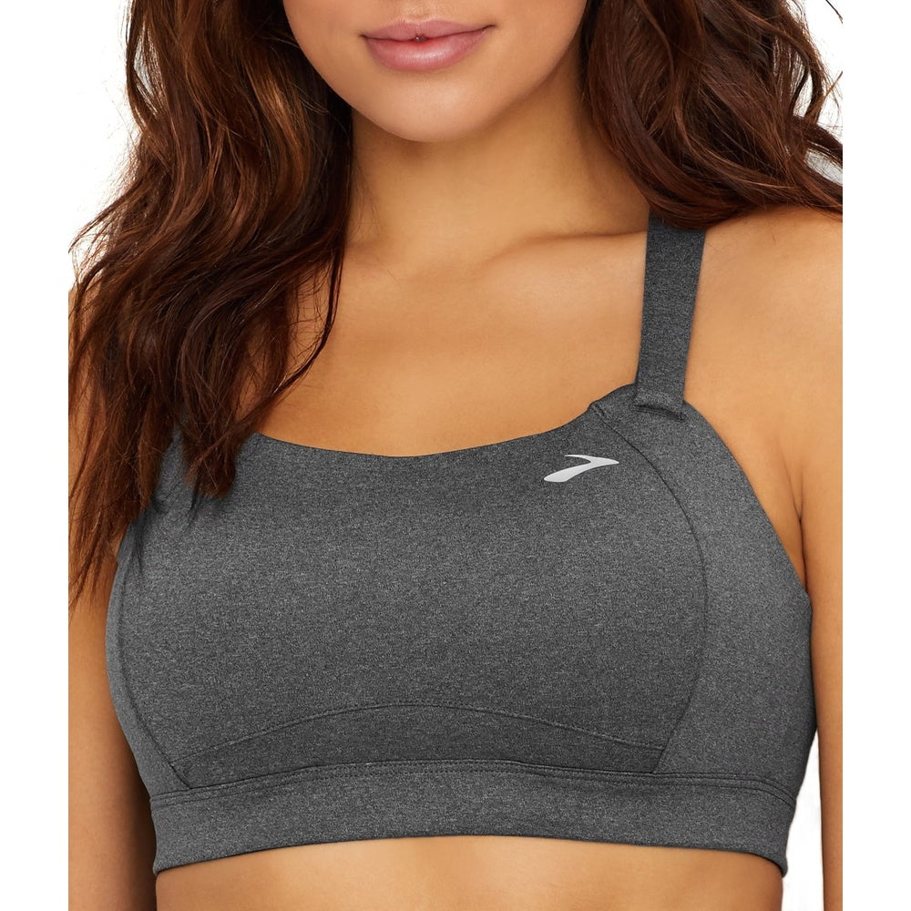 Woman wearing gray Brooks Juno sport bra with white logo