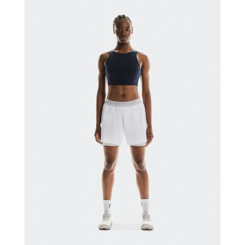 Woman wearing On 3-inch Performance 2-in-1 Shorts in Glacier white colorway
