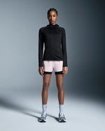 Woman wearing On 3-inch Performance 2-in-1 shorts in mauve and black with matching jacket