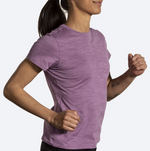 Woman wearing Brooks Luxe short sleeve running shirt in heathered washed plum