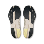 On Cloudsurfer Next men's running shoes outsole view showing black rubber traction pattern and yellow heel