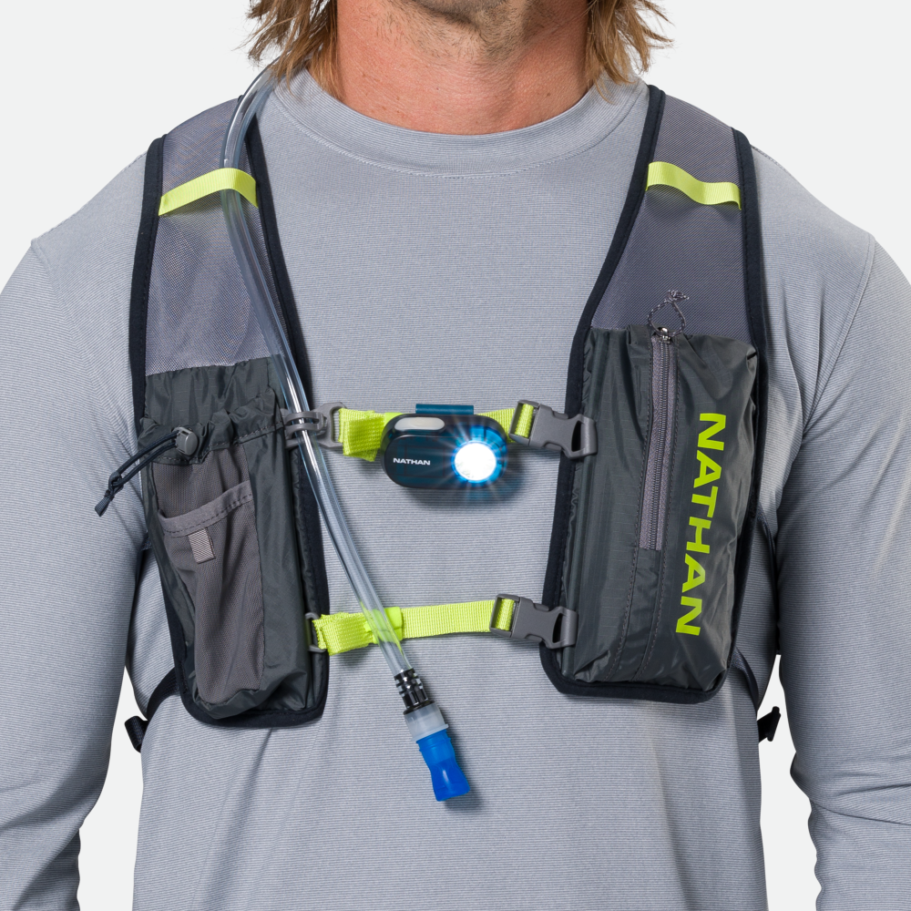 Nathan running vest with LED headlamp and hydration tube on model