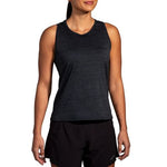 Woman wearing Brooks Luxe Tank in heathered deep black athletic top