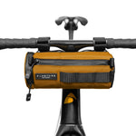 Orange Almsthre compact bar bag mounted on bicycle handlebars with zippered compartments
