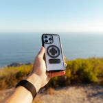 Hand holding Rokform Crystal Case for iPhone showing clear design with circular mount