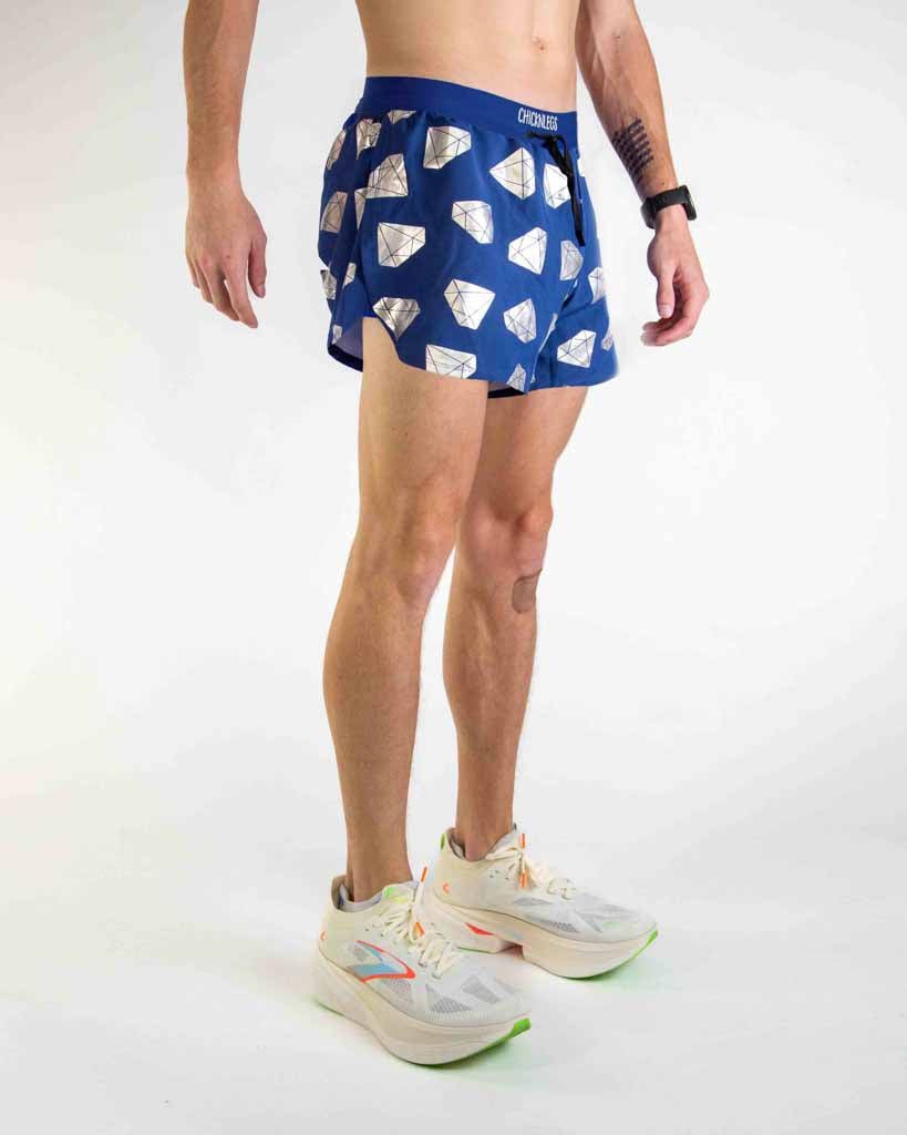 Man wearing blue ChicknLegs running shorts with white diamond pattern and side splits