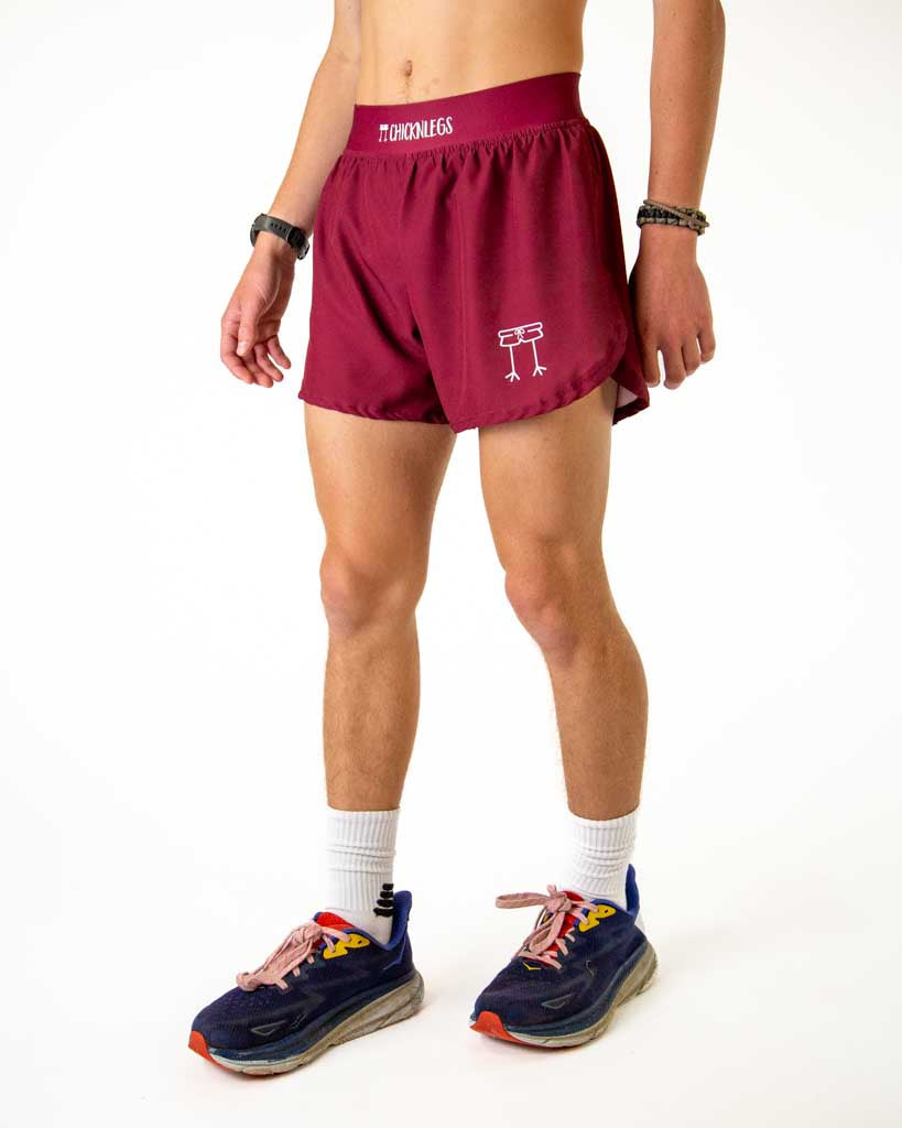 Man wearing ChicknLegs maroon athletic shorts with split sides and logo