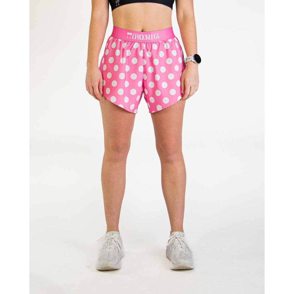 Woman wearing pink polka dot athletic shorts with ChicknLegs branding