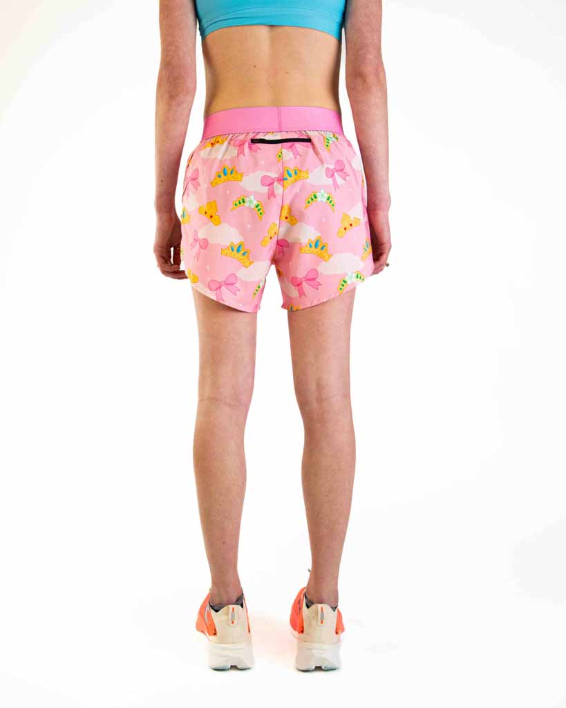 Pink athletic shorts with princess tiara pattern worn by model from behind