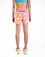 Pink running shorts with colorful princess tiara pattern worn by model from behind