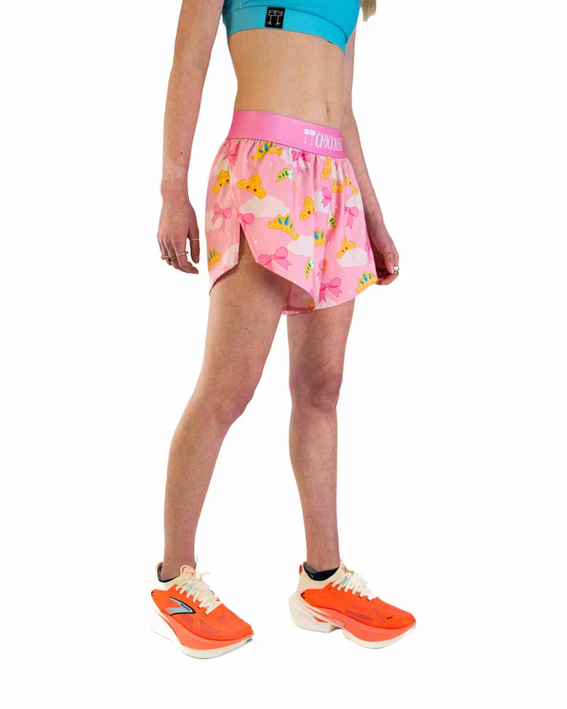 Woman wearing pink ChicknLegs split shorts with princess tiara pattern and running shoes
