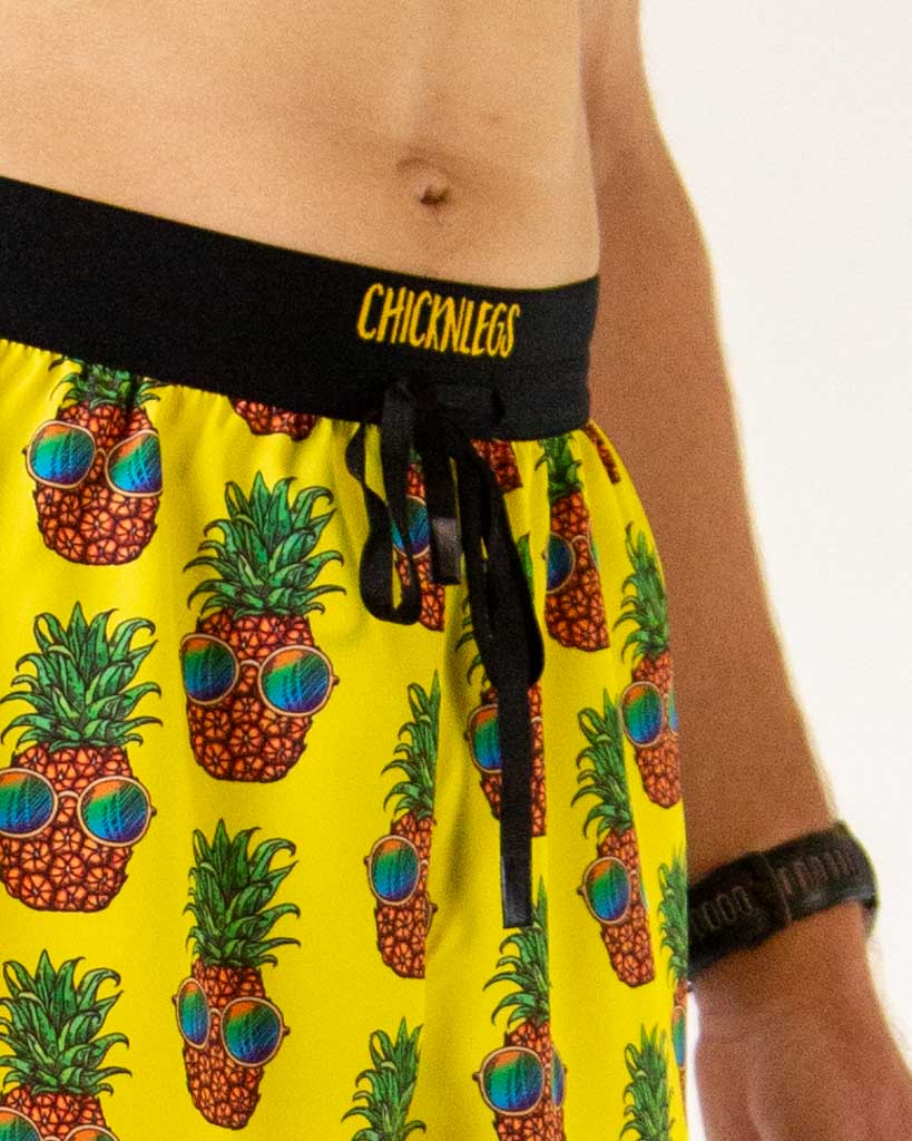 ChicknLegs yellow Pineapple Express split running shorts with black waistband on model
