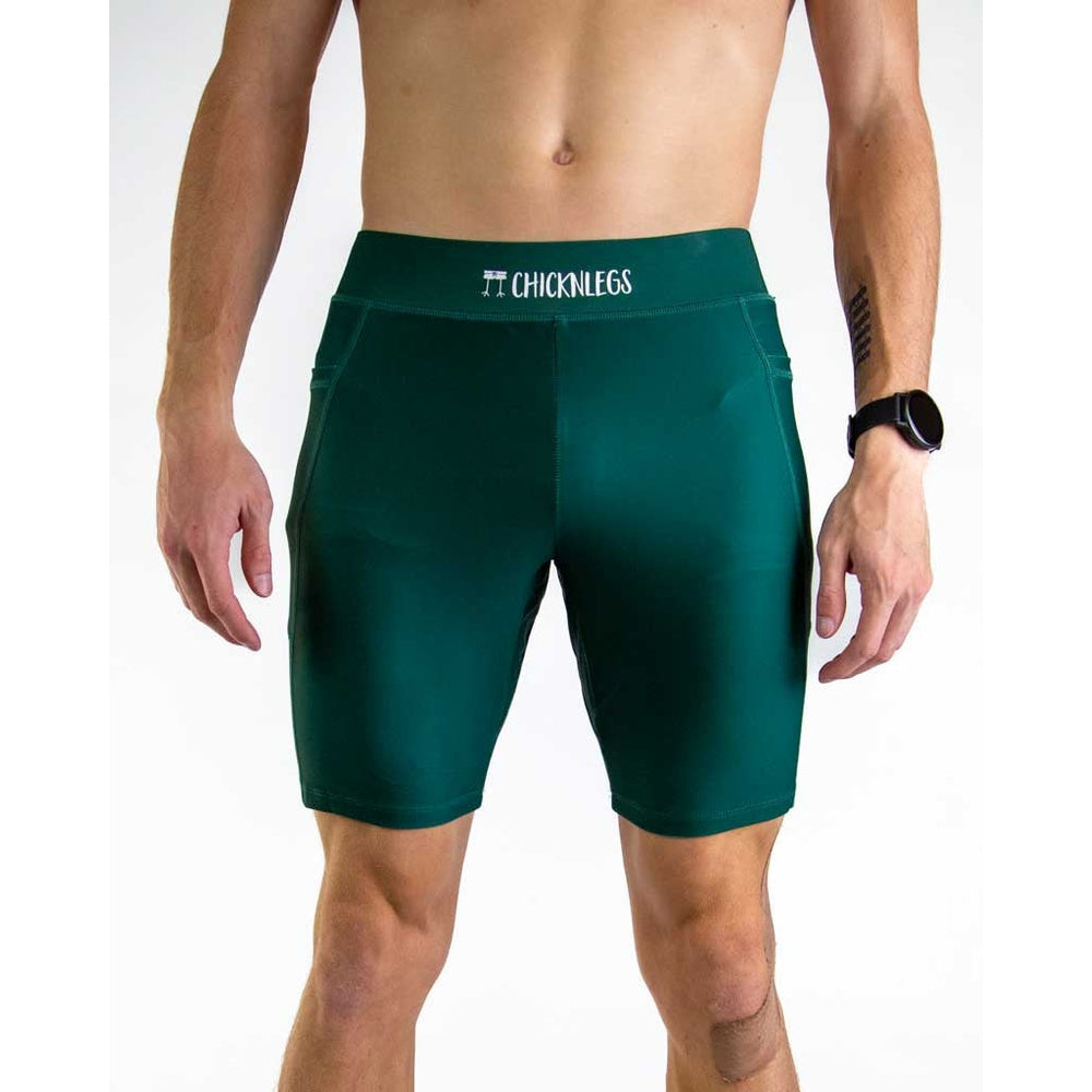 Man wearing ChicknLegs forest green athletic compression shorts with brand waistband