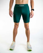 Man wearing forest green ChicknLegs compression shorts with professional studio lighting