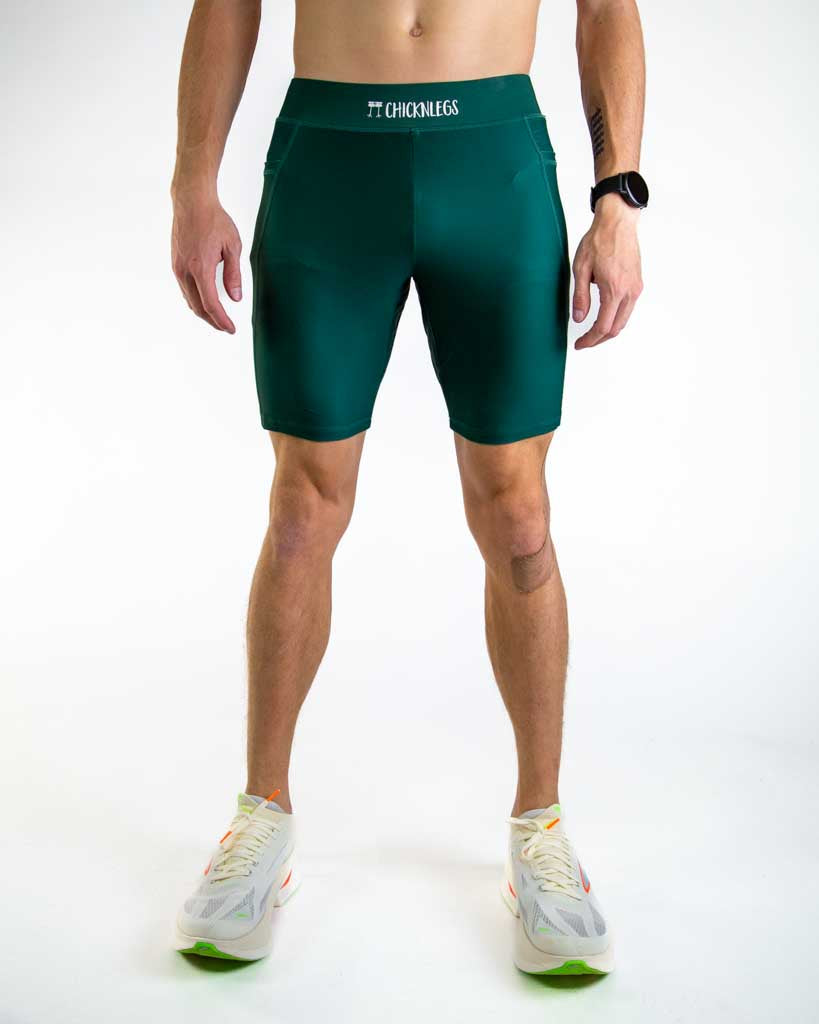 Man wearing forest green ChicknLegs compression shorts with professional studio lighting