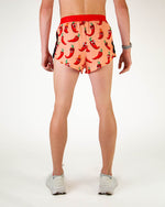 ChicknLegs men's split running shorts with red chili pepper pattern on coral background