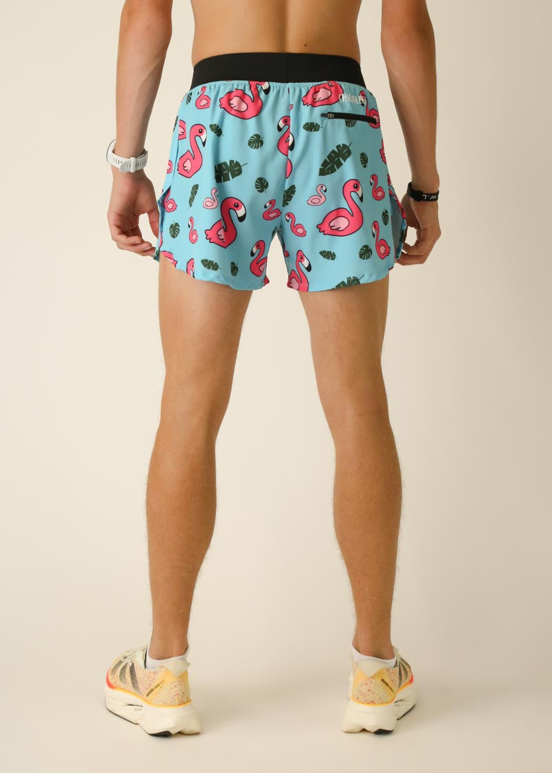 Men's light blue athletic shorts with pink flamingo and tropical leaf print pattern