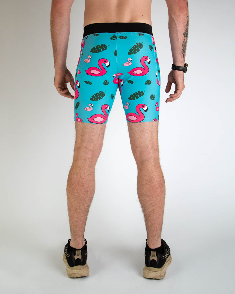 Men wearing turquoise blue compression shorts with pink flamingo and tropical leaf pattern