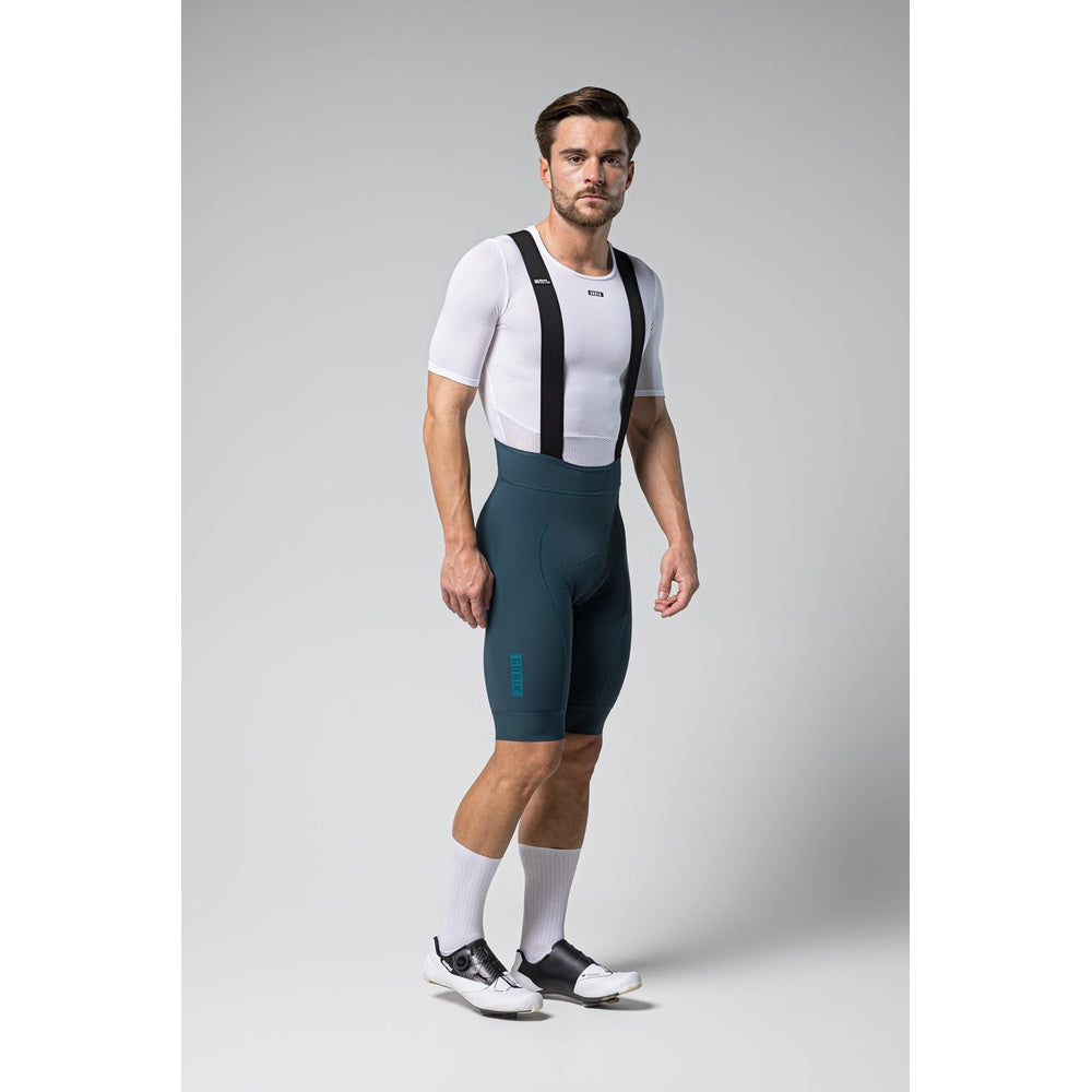 Male cyclist wearing Gobik Matt 2.0 bib shorts in corsair color with white base layer